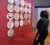 A teacher observes an exhibit piece 