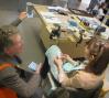 Jeweler Mia Hebib talks with a visitor.: Photo: Molly MacFadden