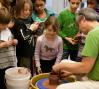 Young students interact with an artist 