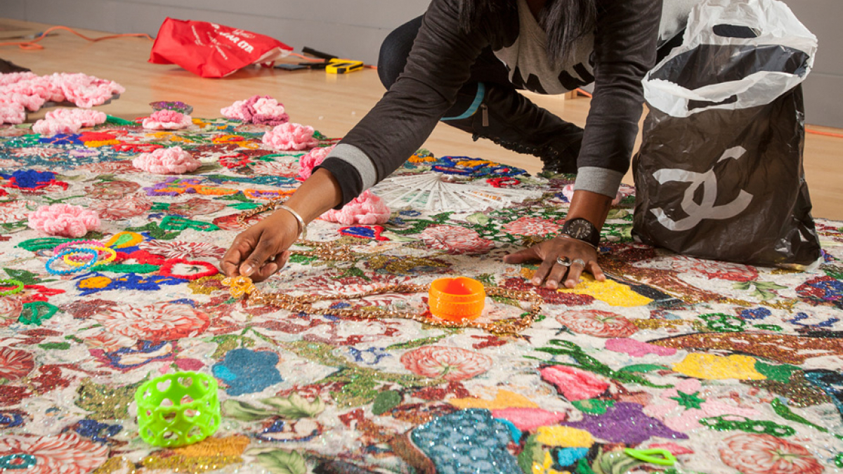 Ebony G. Patterson installing the exhibition Ebony G. Patterson: Dead Treez at the John Michael Kohler Arts Center, 2015