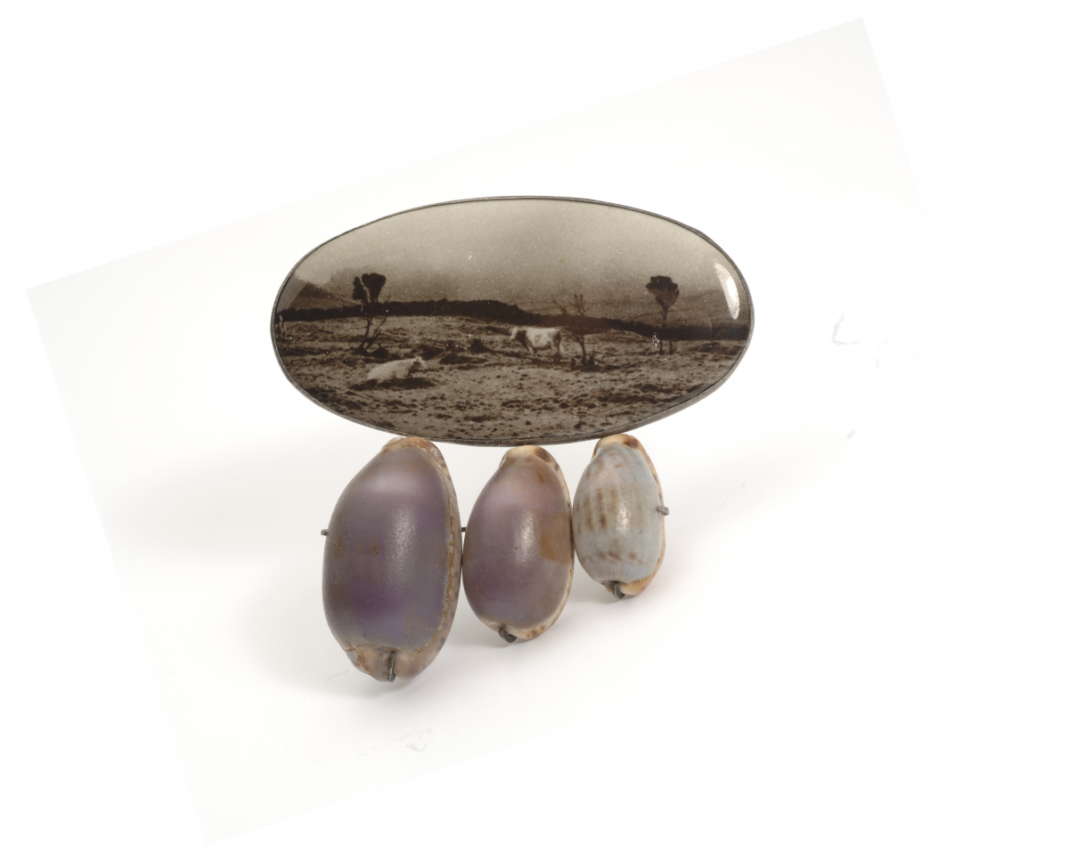 Bettina Speckner, Untitled (brooch), 2004: Artist’s photograph enameled on silver, cowrie shells, amethysts; Courtesy of a private collection; Photo credit: Bettina Speckner